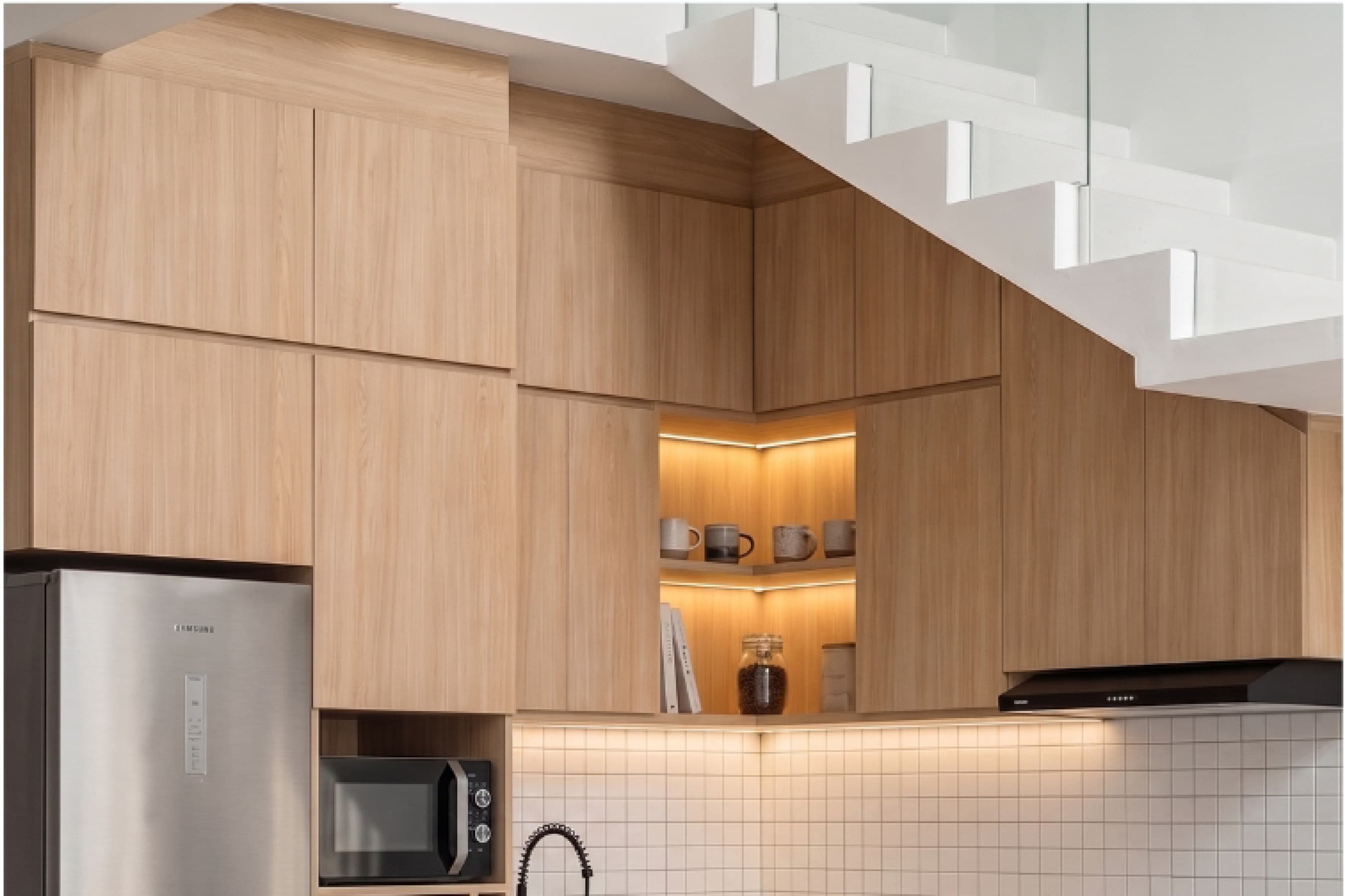 Kitchen with timber cabinetry and a glass sliding door opening onto a small patio.