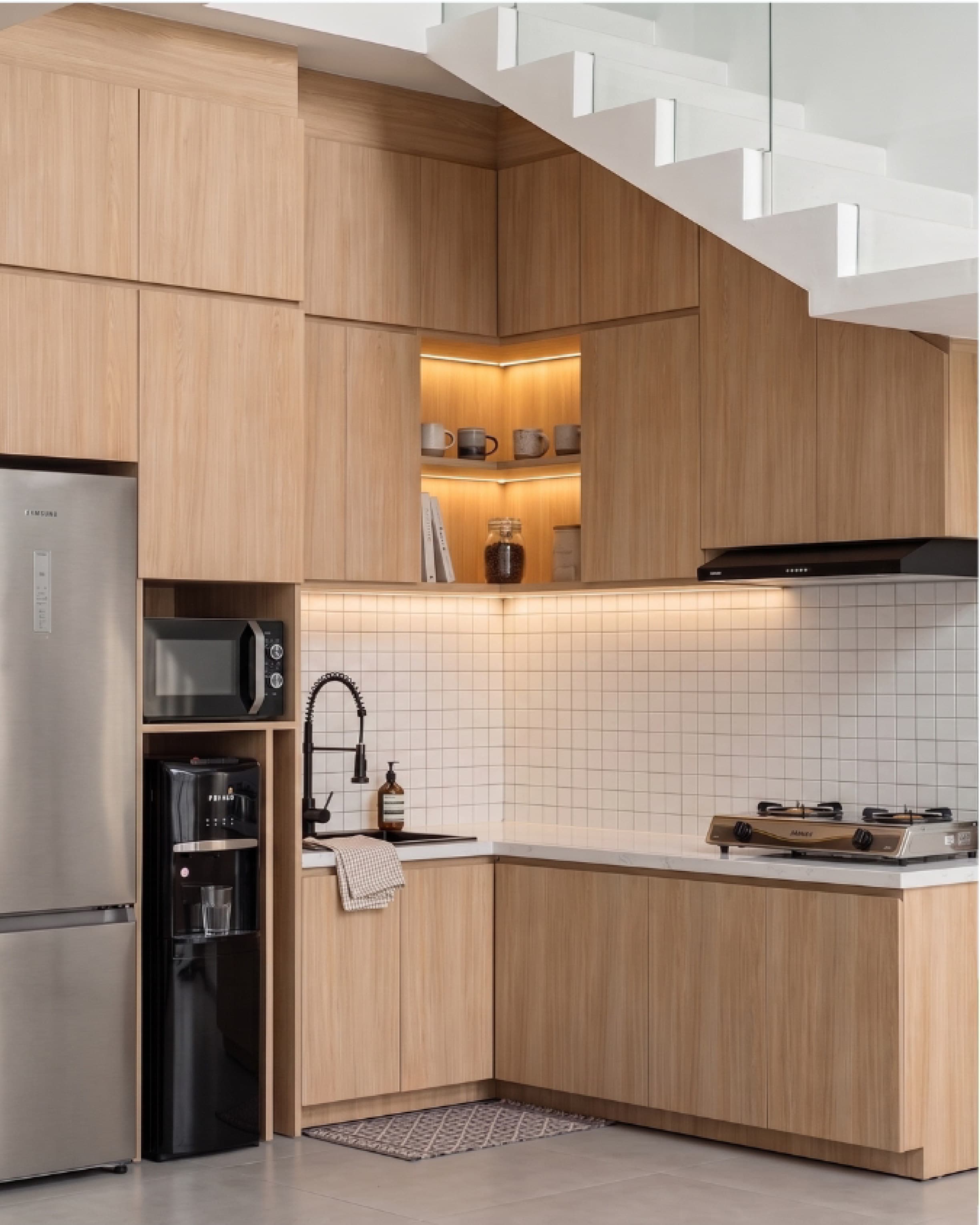 Kitchen with timber cabinetry and a glass sliding door opening onto a small patio.