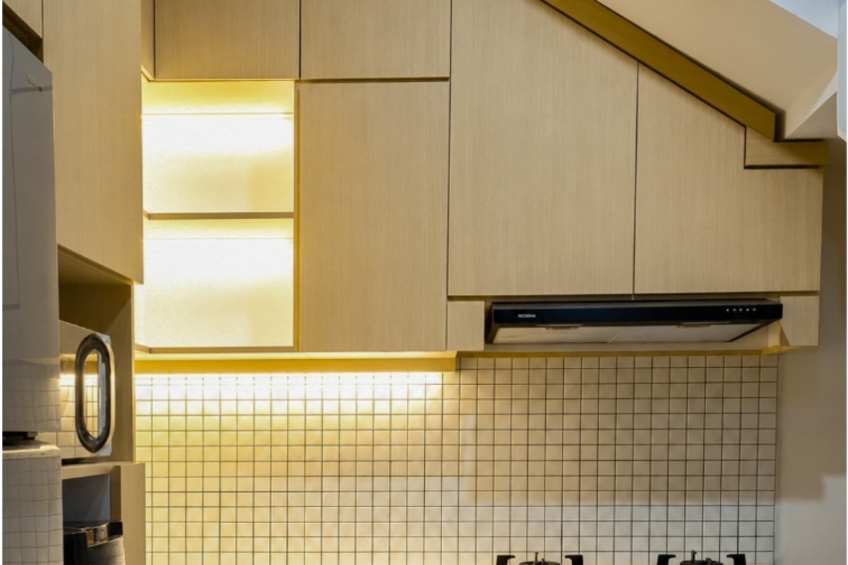 Site documentation of a built kitchen cabinet with under-shelf lighting and a tiled backsplash.