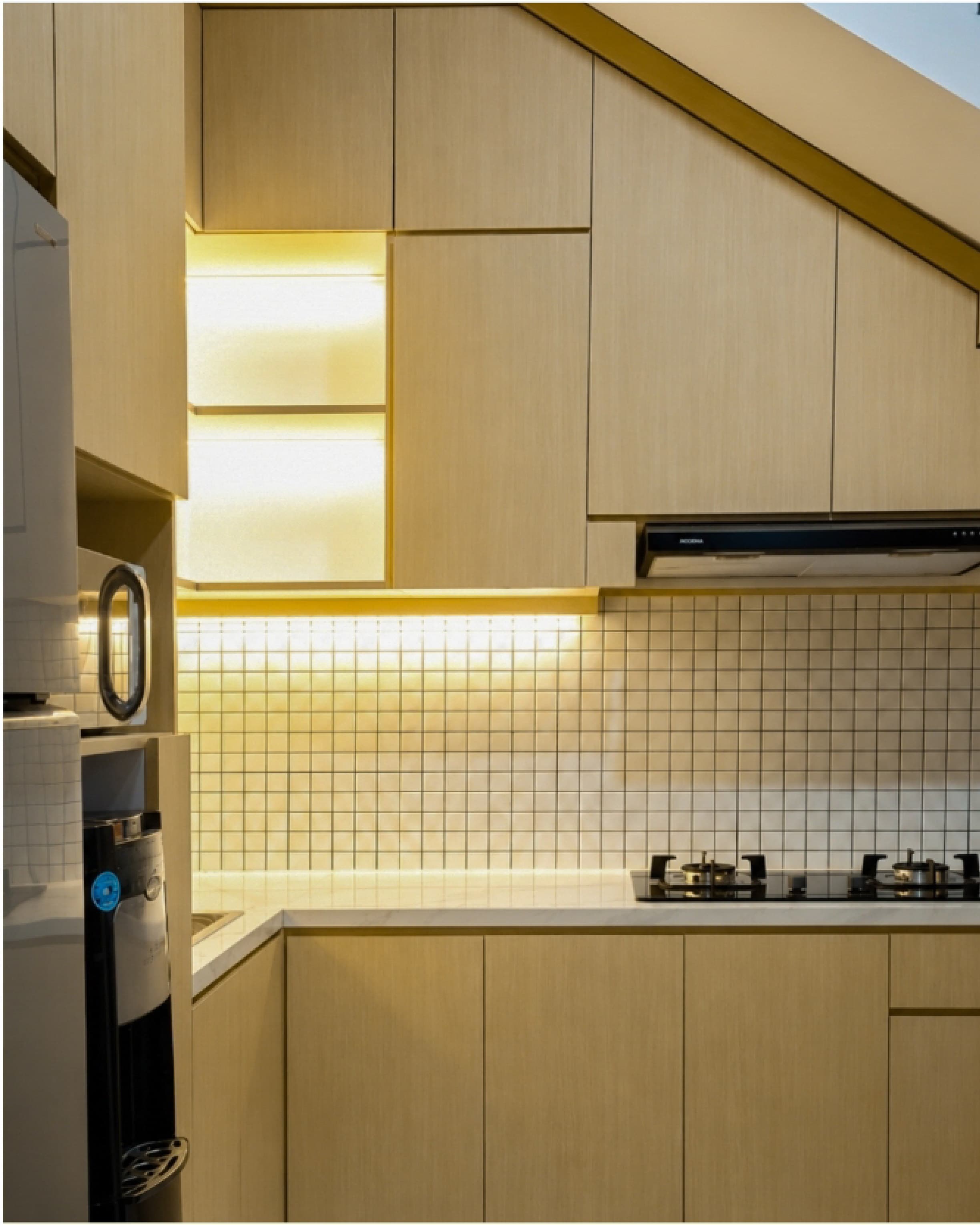 Site documentation of a built kitchen cabinet with under-shelf lighting and a tiled backsplash.