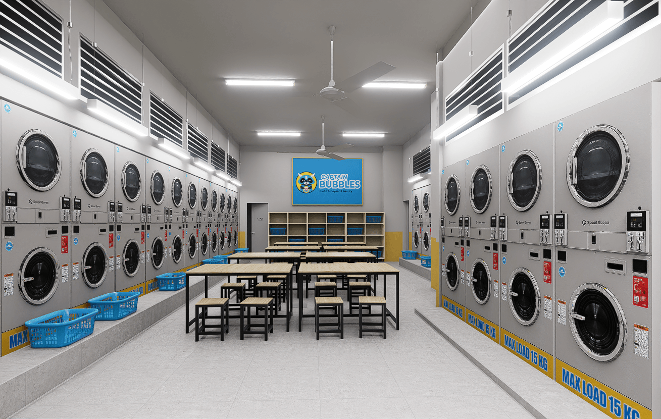 Self-service hall lined with stacked washers and dryers, folding tables and blue baskets down the middle.