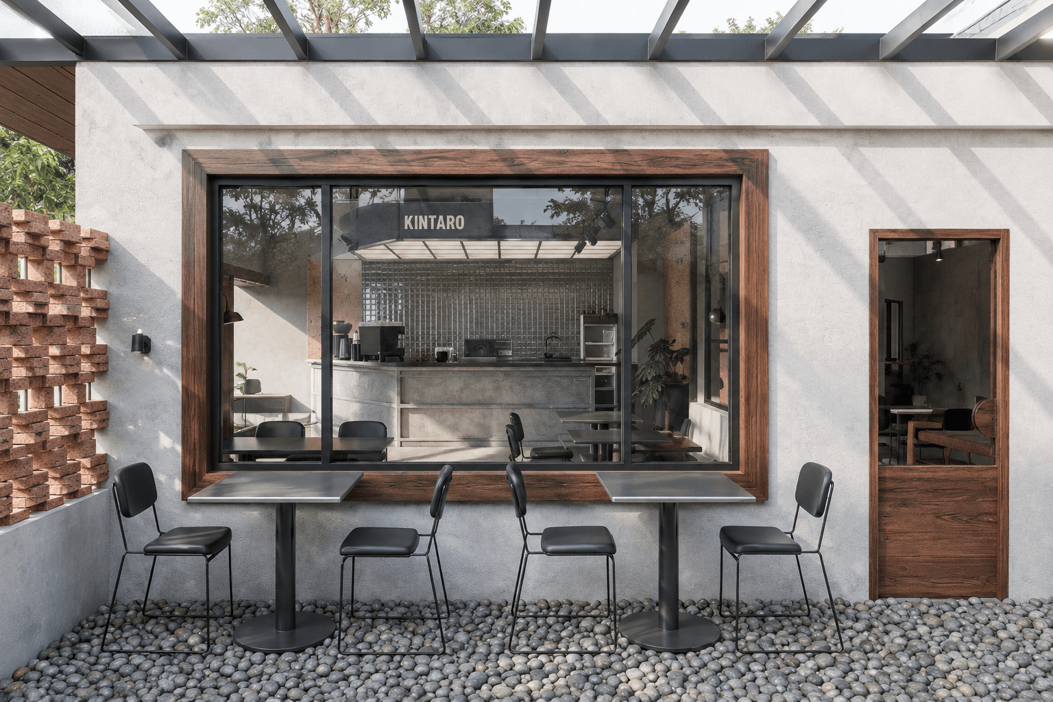 Courtyard seating on pebbles, facing the timber-framed window into the bar.