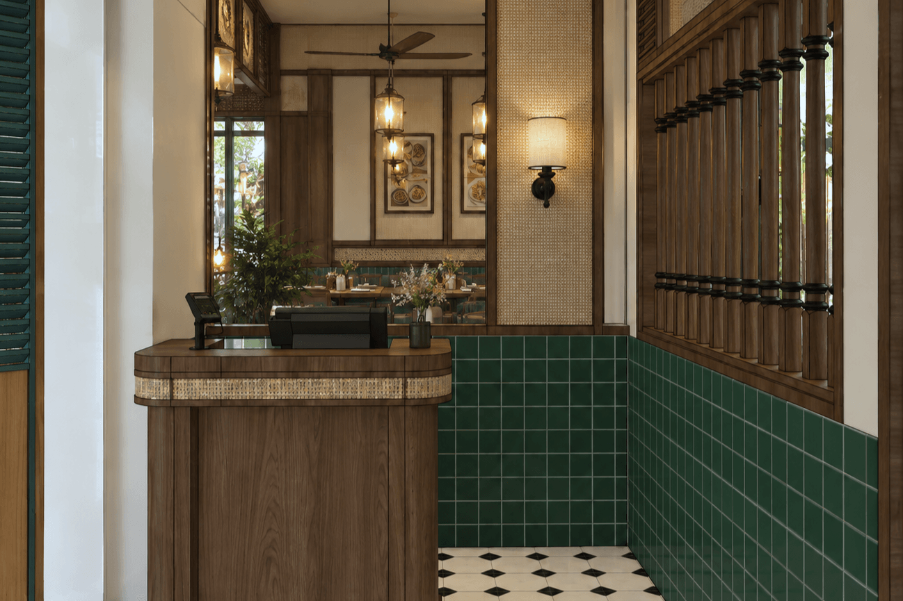 Timber counter against green wall tiles, with rattan pendants, wall lamps and a timber lattice partition.