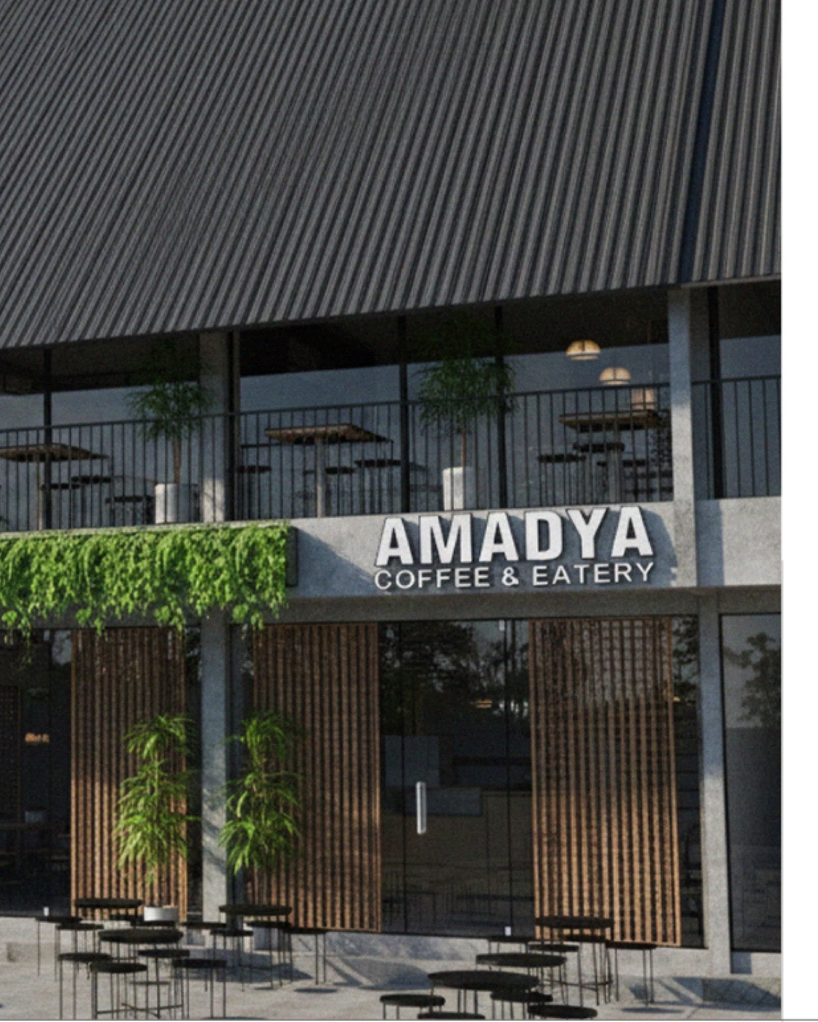 Amadya storefront with a dark corrugated roof, hanging greenery along the fascia and an open terrace below.