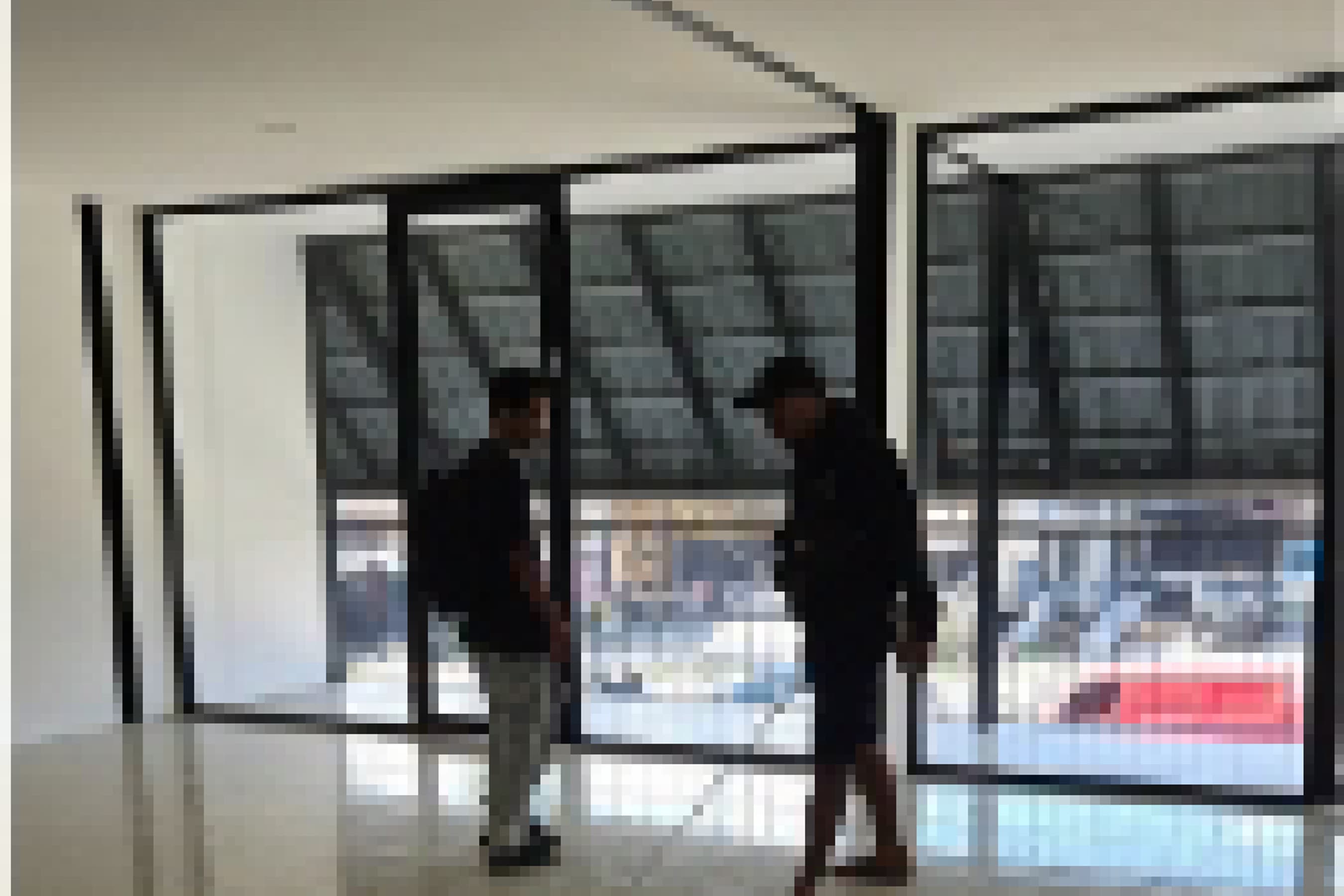 Site documentation photograph inside the glass-walled shopfront during a construction visit.