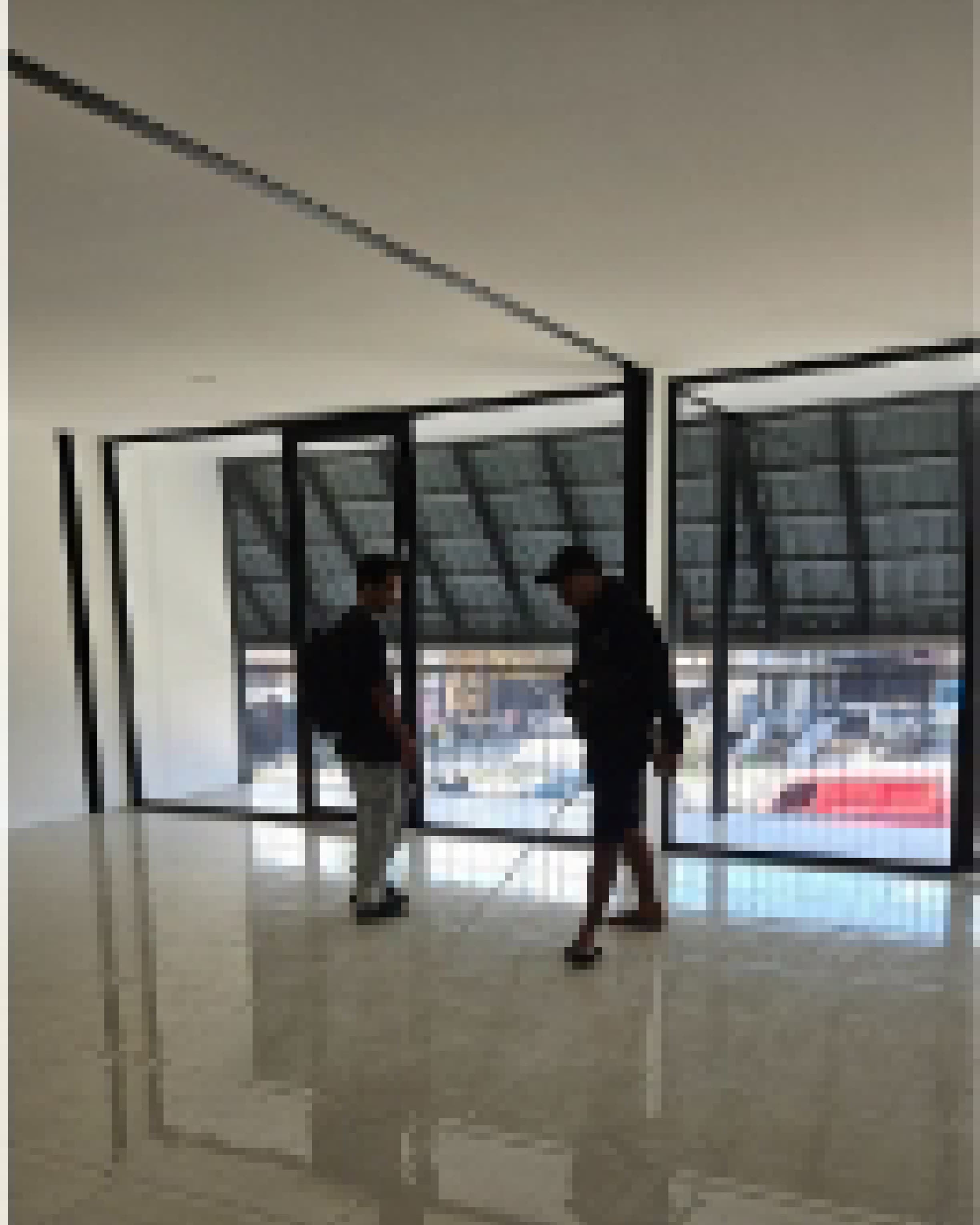Site documentation photograph inside the glass-walled shopfront during a construction visit.