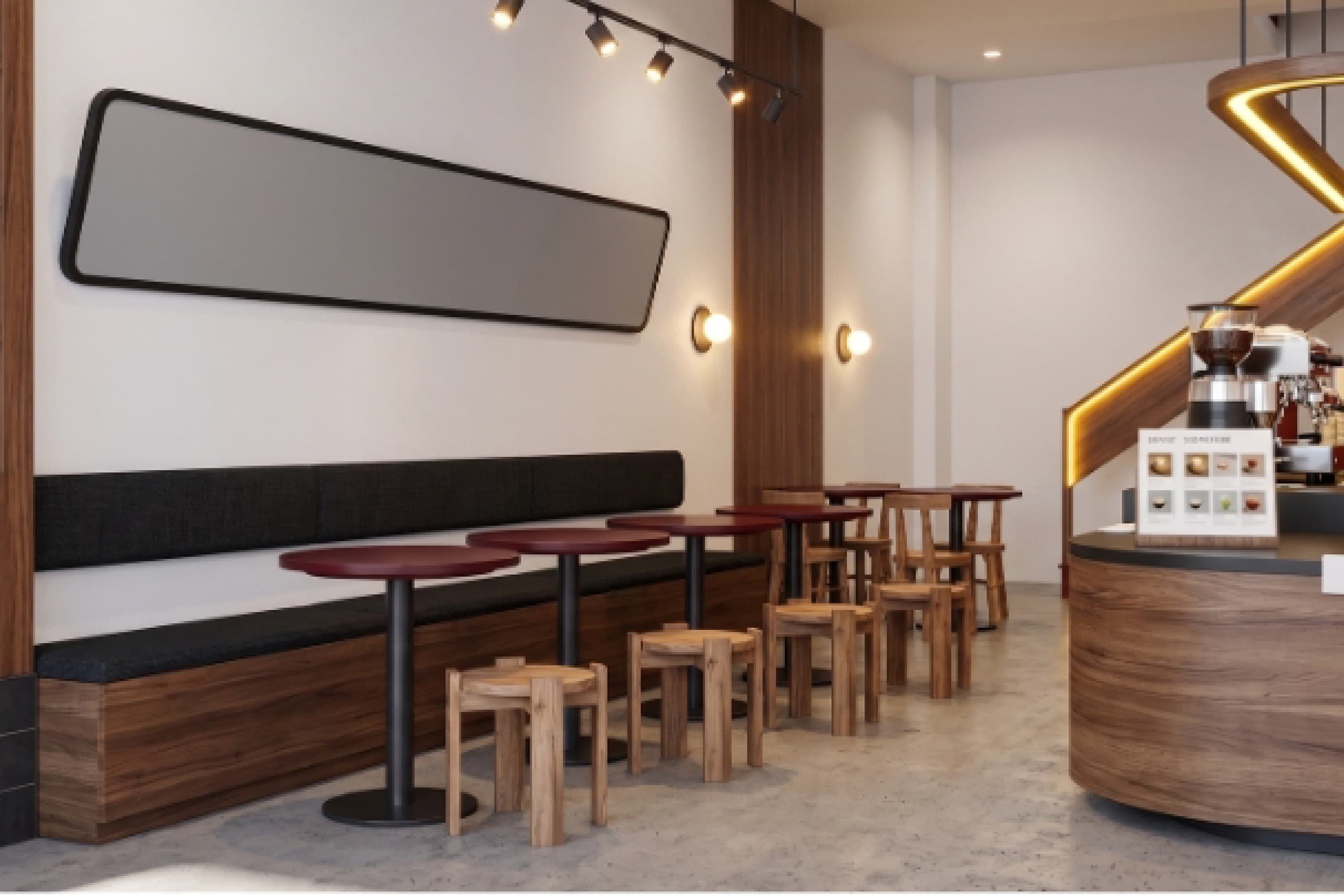 Wide interior view with bench seating, red accents and the counter visible in the background.