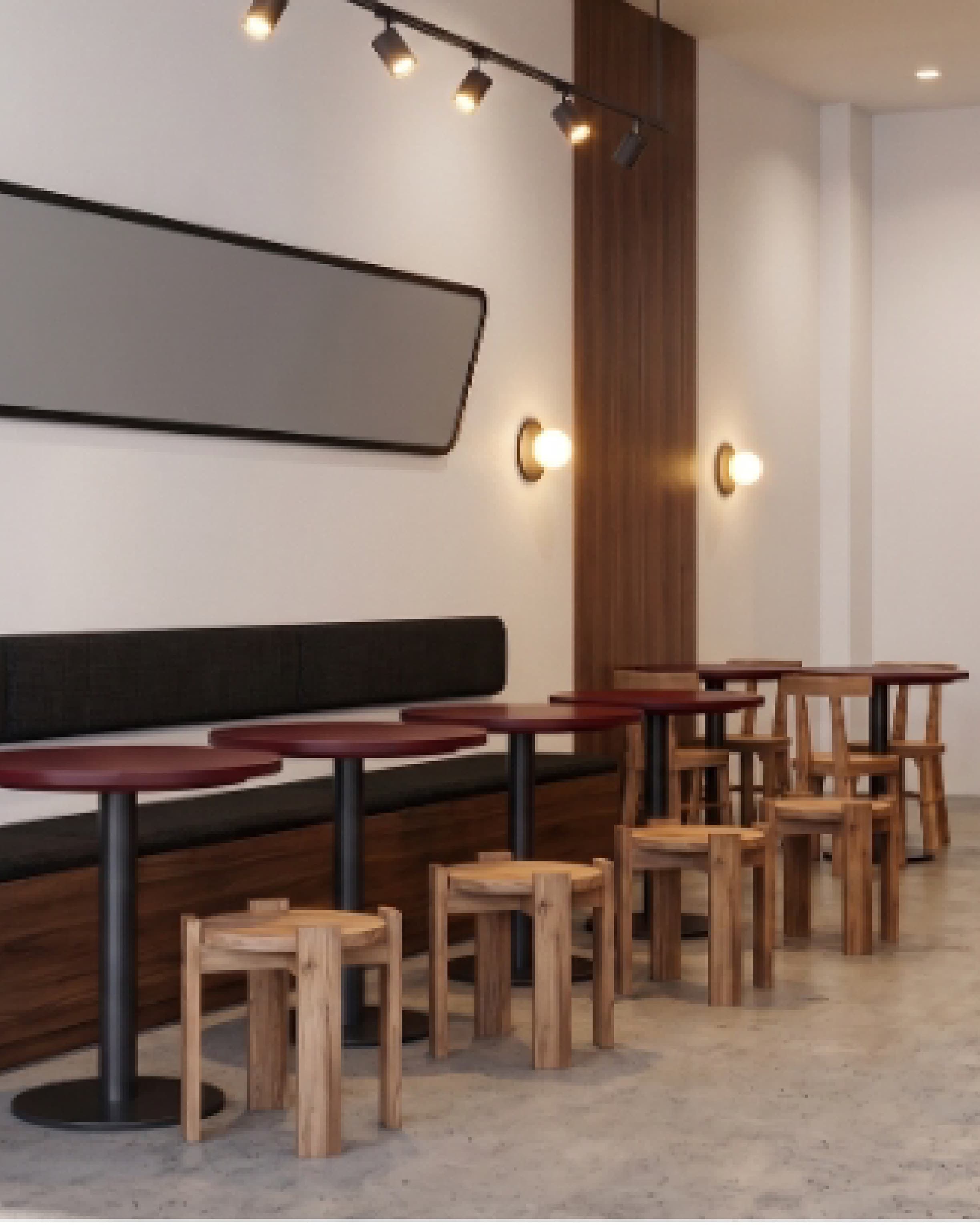 Wide interior view with bench seating, red accents and the counter visible in the background.