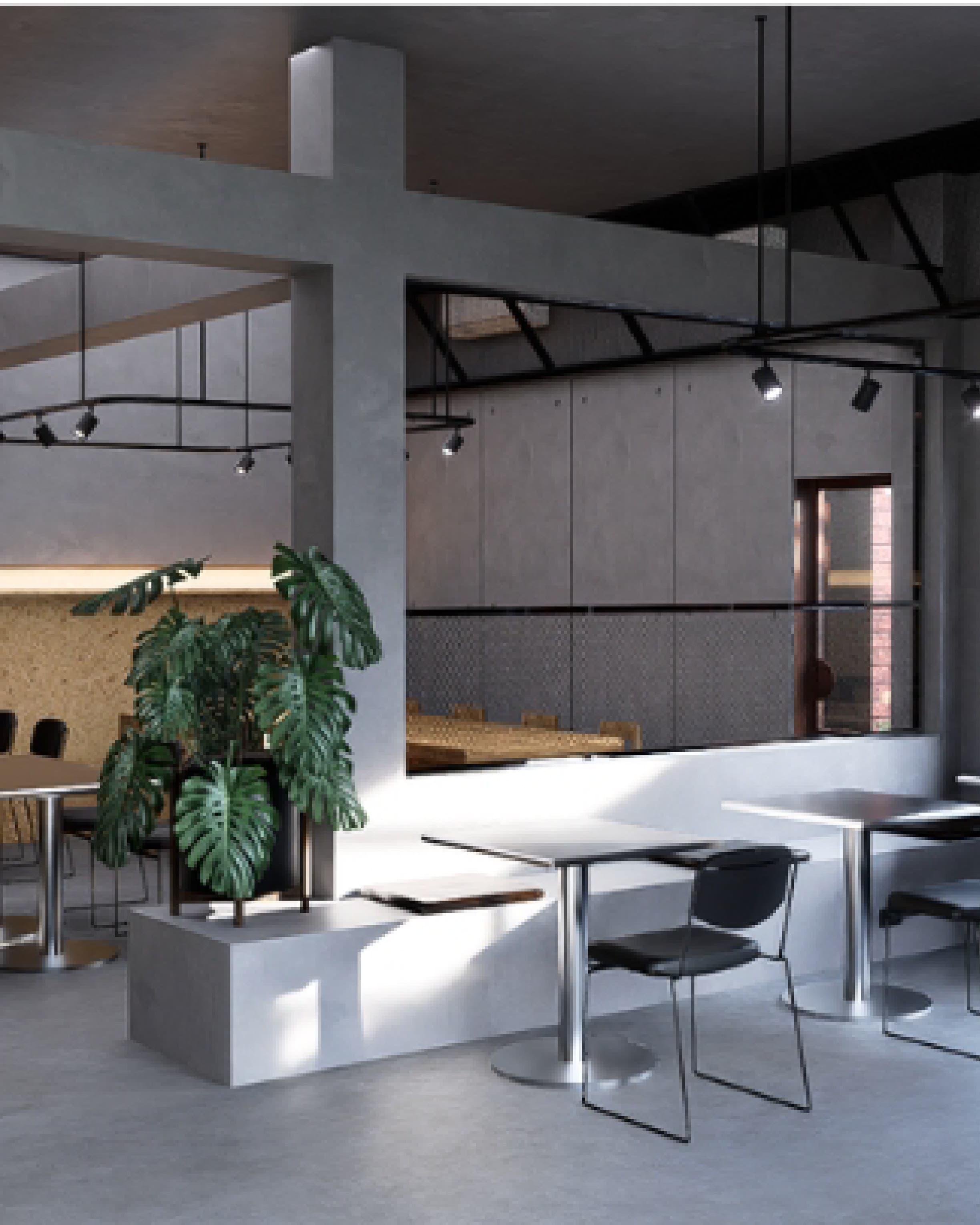 Counter area in dark tones with potted plants softening the concrete-toned finish.