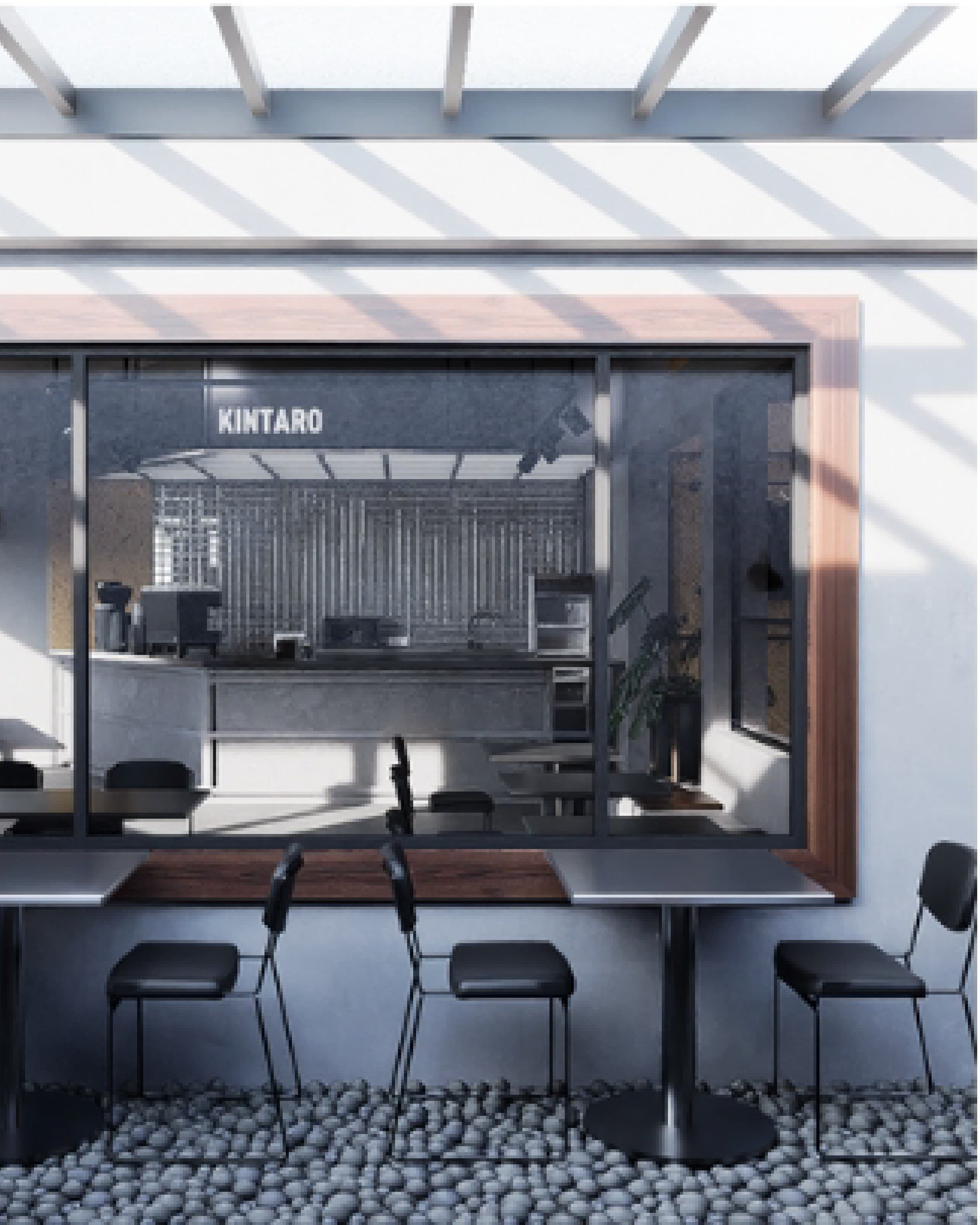 Seating area with black chairs and timber tables arranged between structural columns.