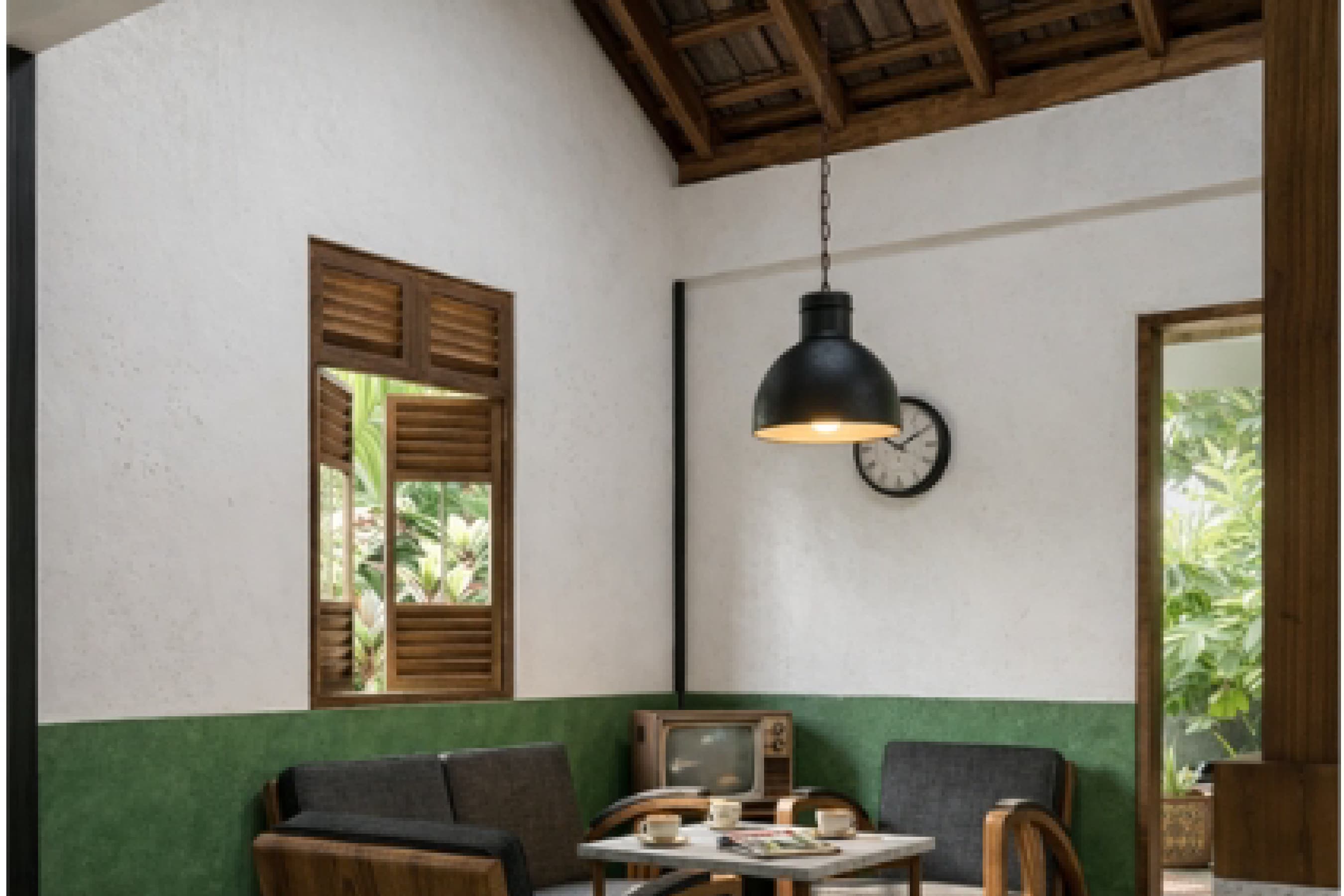 Communal interior with white walls, timber shutters and a pendant lamp over a green wainscoted wall.
